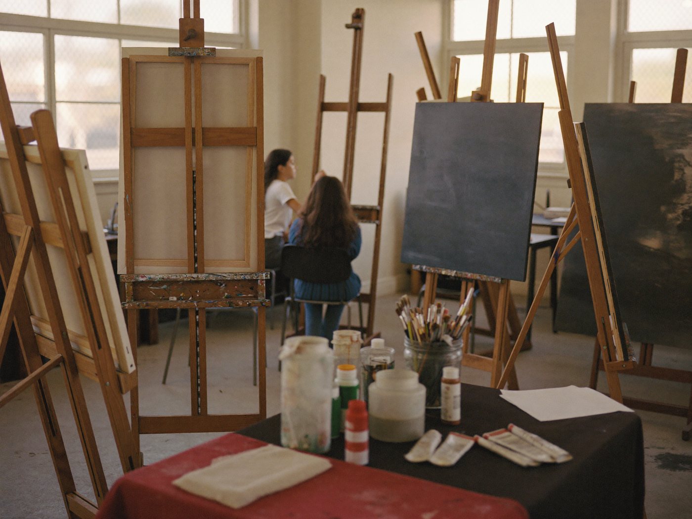 Art studio with easels, brushes and student work